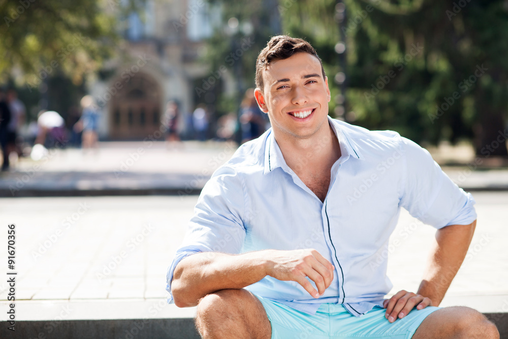 Fototapeta premium Attractive young fit man is resting outdoors