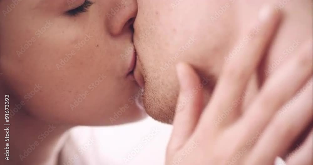 Close up of sexy young couple kissing engaged in foreplay touching each other