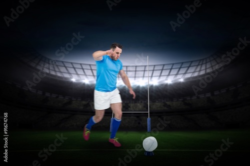 Composite image of rugby player ready to kick
