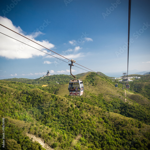 Cable Car way to mountains with statue of buddha