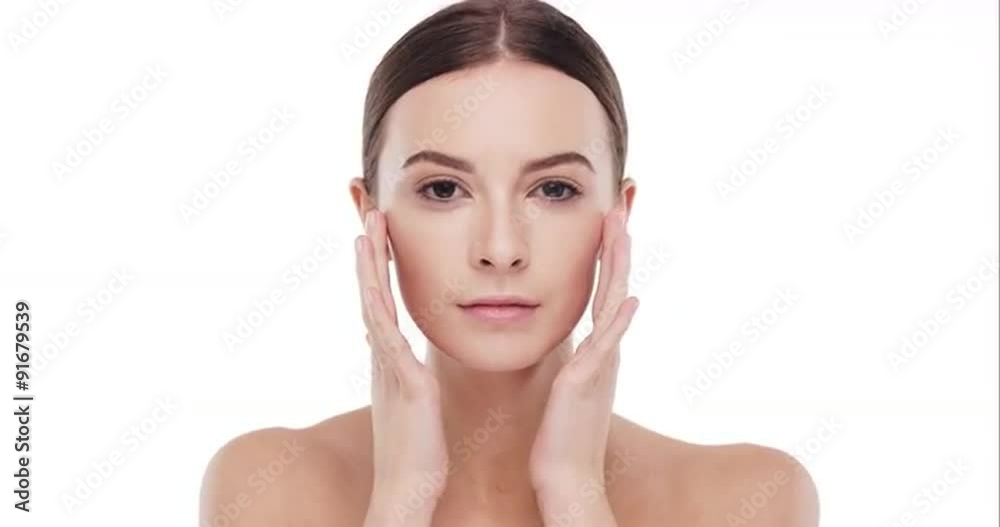 Beauty portrait of woman touching beautiful face in slow motion skincare concept on a white background Beauty portrait of woman touching beautiful face in slow motion skincare concept on a white background