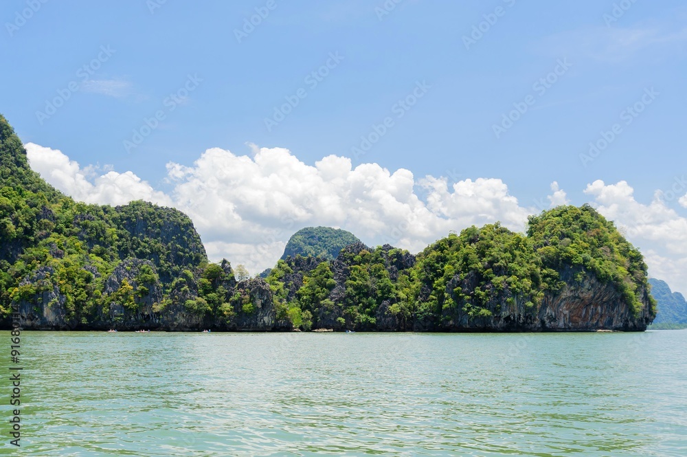 Mountain forest and sea water on White cloud on blue sky