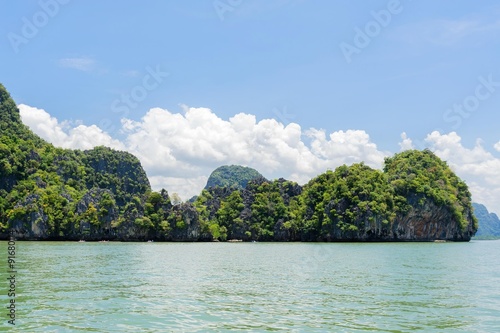 Mountain forest and sea water on White cloud on blue sky