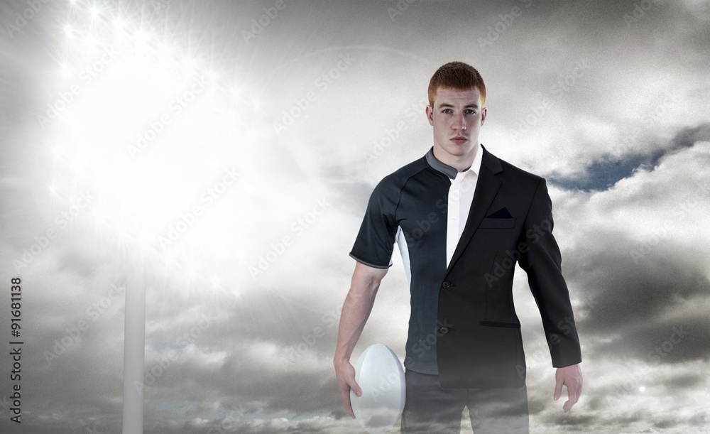 Composite image of rugby player holding a rugby ball Composite image of rugby player holding a rugby ball