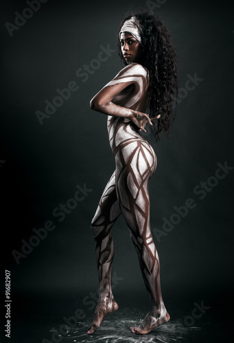 Sensual african model posing with body painted with polygons