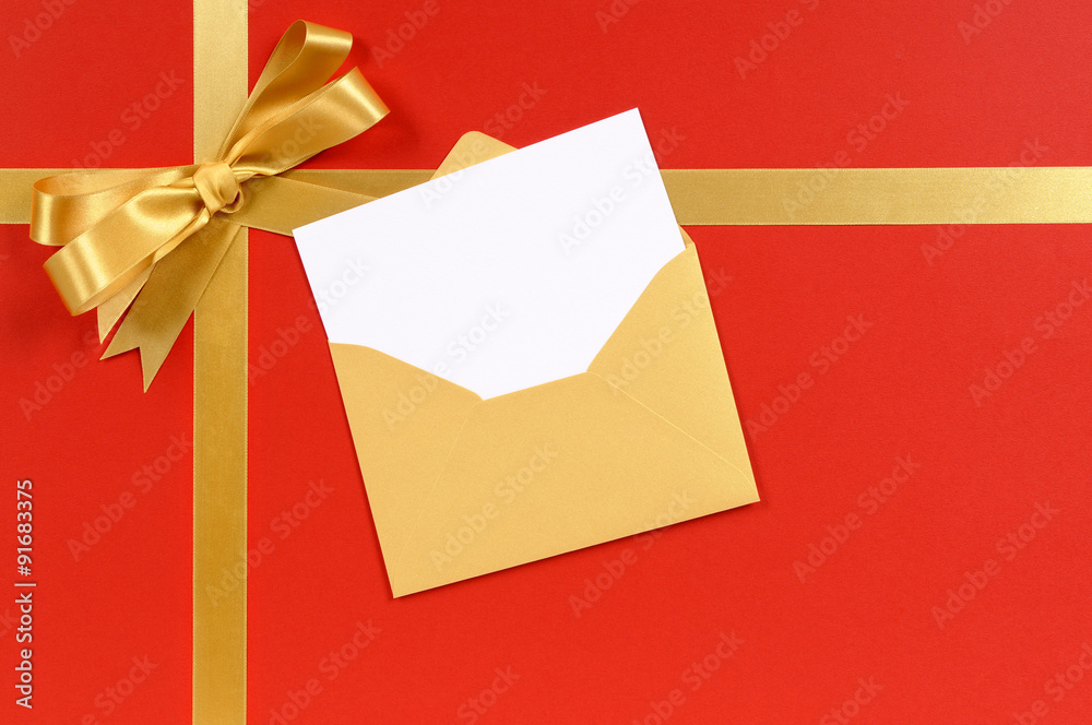 Gold gift bow and ribbon with christmas birthday or greeting card on a red wrapping paper present background photo Gold gift bow and ribbon with christmas birthday or greeting card on a red wrapping paper present background photo