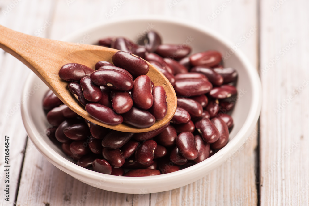 Kidney Beans in wooden spoon with ceramic bowl Kidney Beans in wooden spoon with ceramic bowl