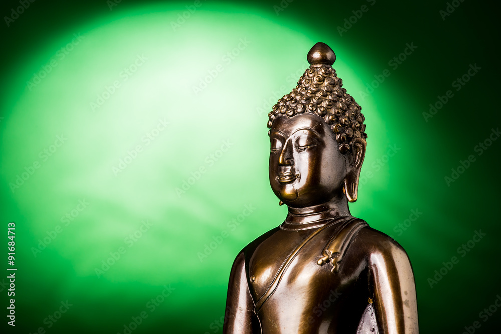Buddha statue on green background