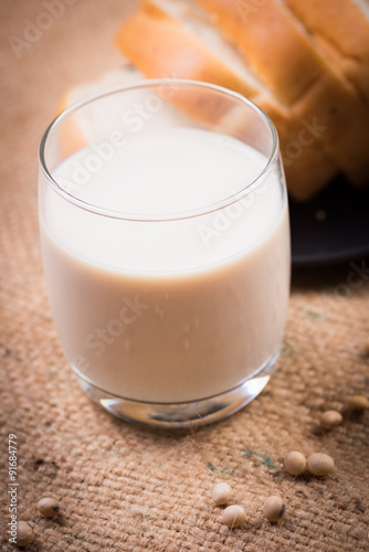 Soybeans and soy milk in a glass with fresh buns. selective focu