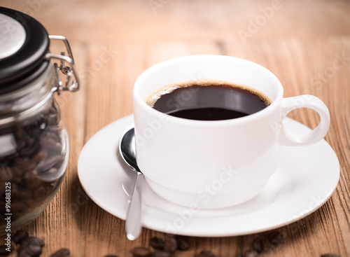 Coffee cup and saucer on a wooden table.