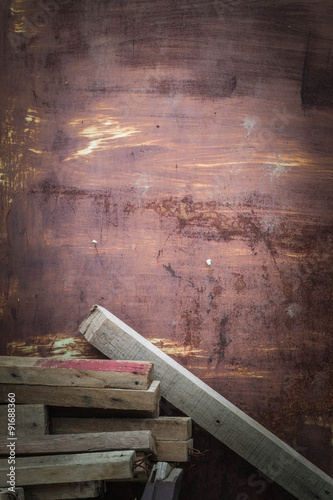 Wood piles on iron door.