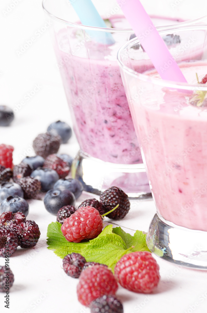 Assorted fruit shakes on white table Assorted fruit shakes on white table