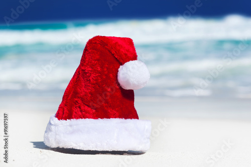 Santa Hat on white sandy beach