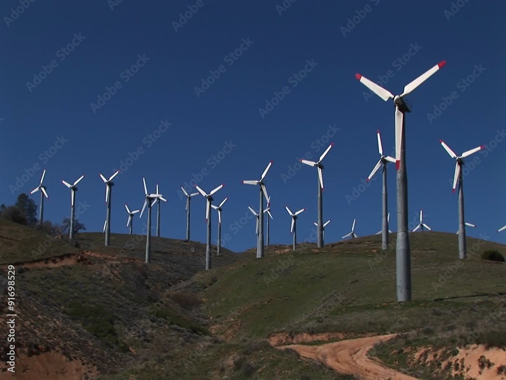 Long-shot of numerous wind turbines generating power at Tehachapi, California. Long-shot of numerous wind turbines generating power at Tehachapi, California.
