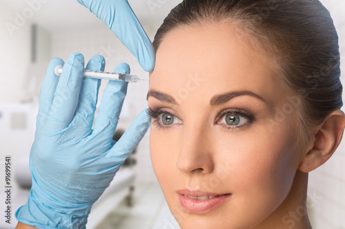 Beauty woman giving botox injections.