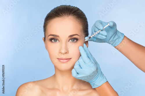 Beauty woman giving botox injections.