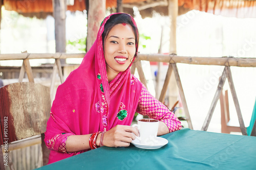 nepali woman drinking coffee or tea photo