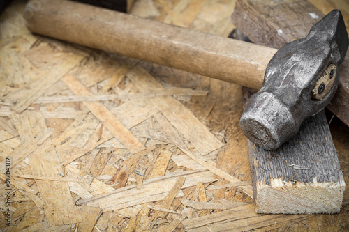 Hammer on a wooden background