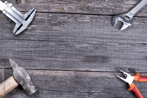 Different construction tools on a wooden background