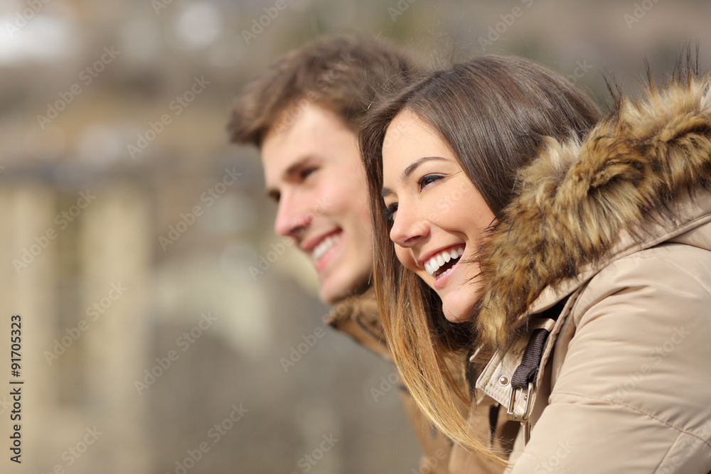 Couple profile looking forward in winter Couple profile looking forward in winter