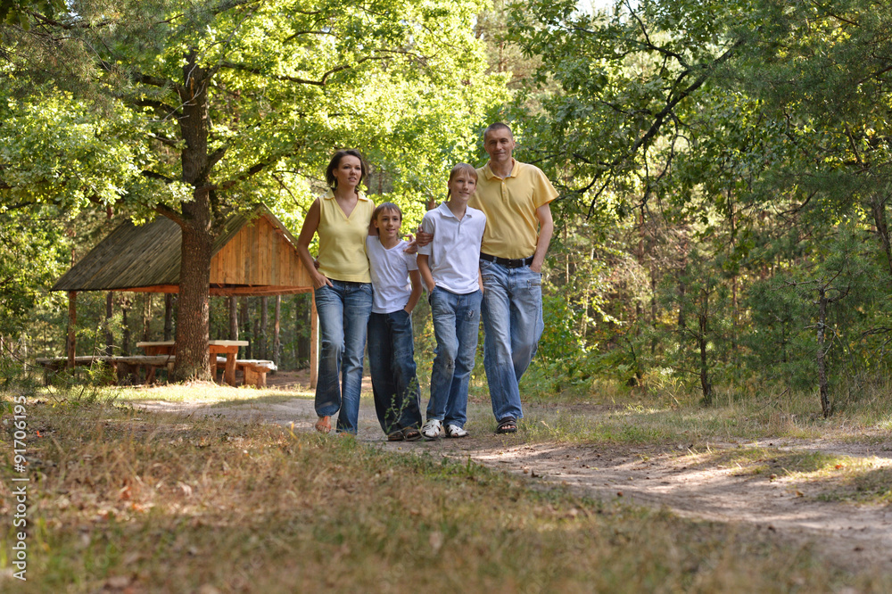 Family of four enjoying golden leaves