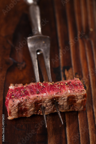 beef steak Slice on vintage meat fork