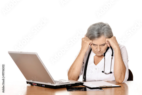  Senior female doctor with laptop