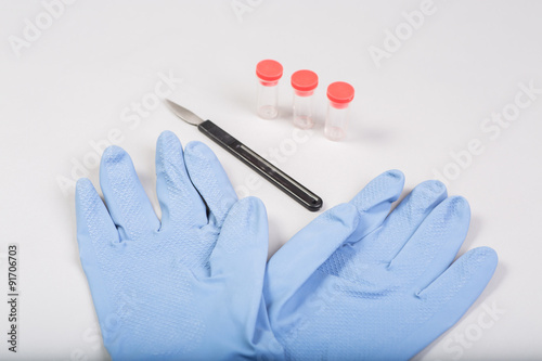 Gloves with scalpel and test tubes