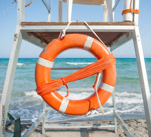 Orange life preserver on a beach