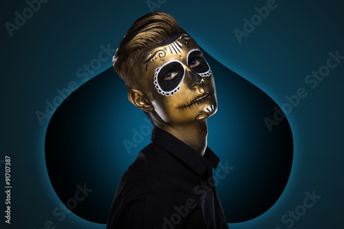 The guy with the painted face for Halloween. Masquerade Party. Night festivities dressed as zombies. Face art