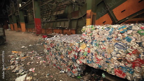 A skip loader moves aluminum cans at a recycling center. photo