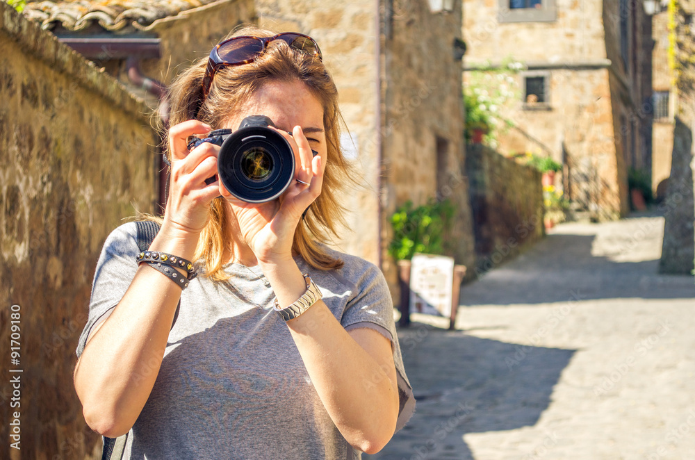 tourist woman photographs the old village of Bagnoregio - Viterbo - Italy