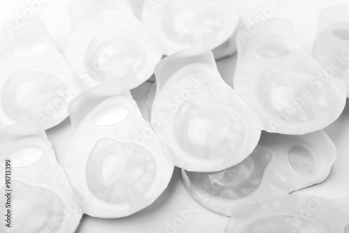 Obraz na plátně Several packs of contact lens on white surface.