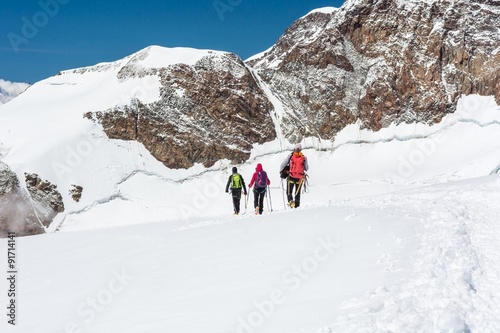 Group of climbers walking on a glacier. © anzebizjan