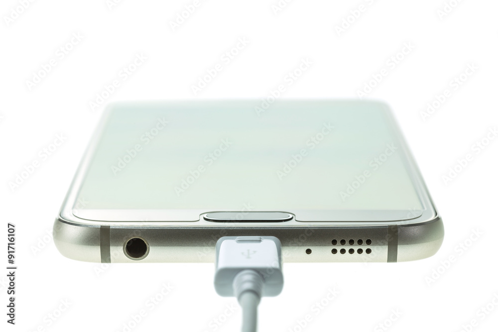 Macro Smartphone connect with charger isolated on white Macro Smartphone connect with charger isolated on white