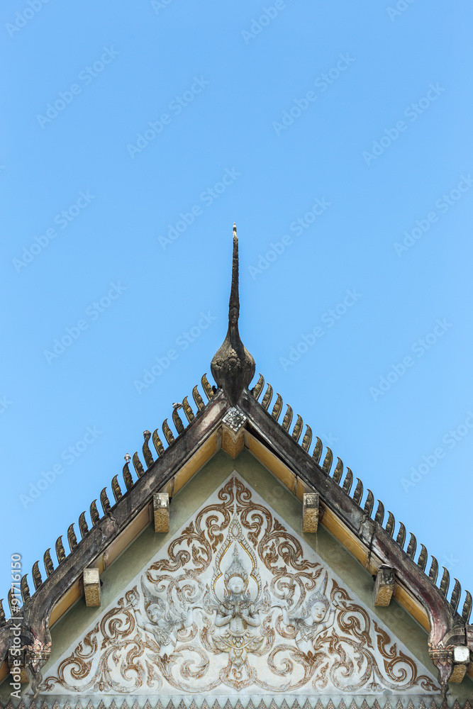 Old Thai style temple roof and blue sky