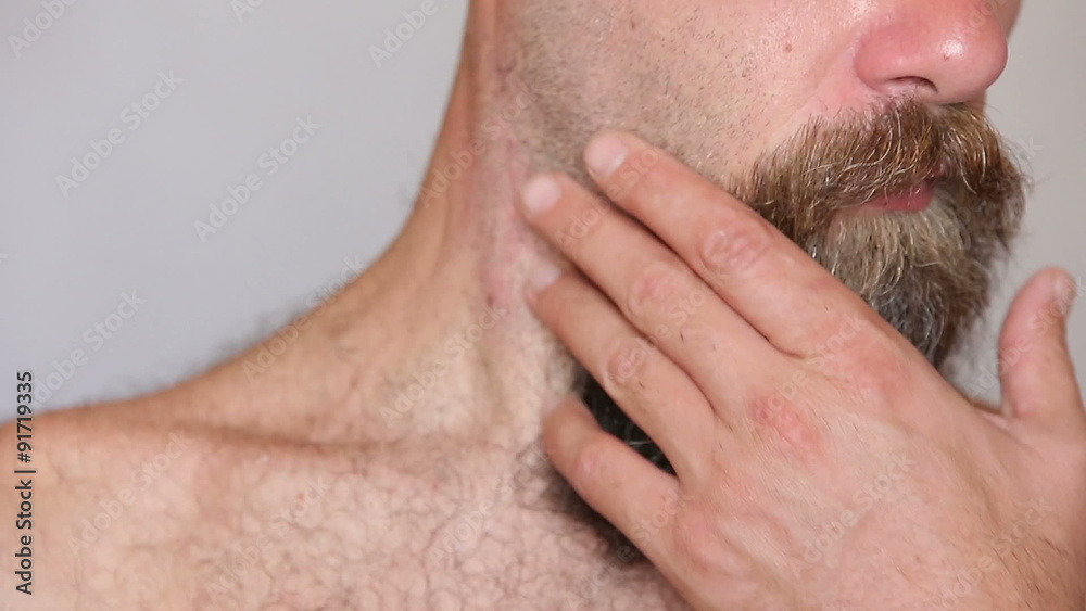 Extreme Close up of a shirtless man taking care of his lush Extreme Close up of a shirtless man taking care of his lush