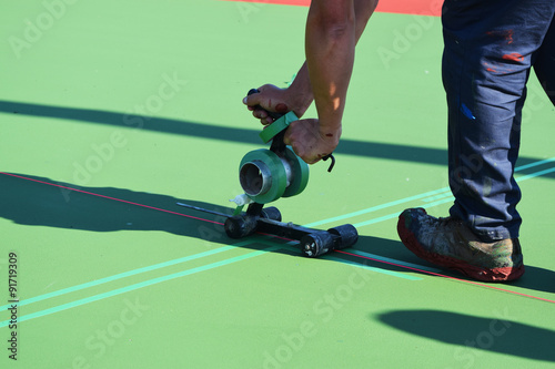 Masking to paint lines on tennis court