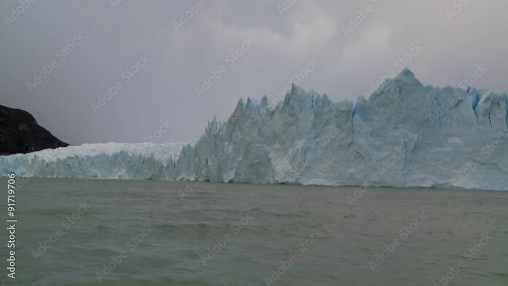POV from a boat traveling along the edge of a glacier. POV from a boat traveling along the edge of a glacier.