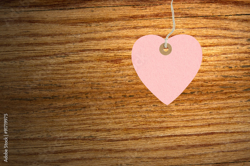 pink heart made of paper on wooden background