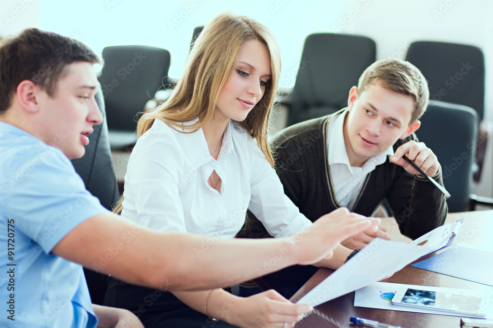 Young beautiful business woman with business partners, men at a Young beautiful business woman with business partners, men at a