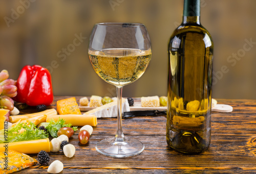 Fototapeta Naklejka Na Ścianę i Meble -  White Wine on Rustic Table with Cheese and Fruit