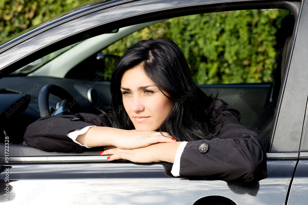 Business woman sitting in car thinking Business woman sitting in car thinking