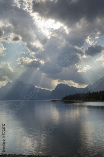 Dramatic clouds, sun rays over Jackson Lake, Jackson Hole, Wyomi photo