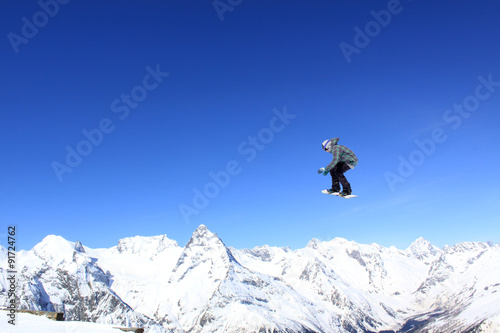 Flying snowboarder on mountains © Vasily Merkushev