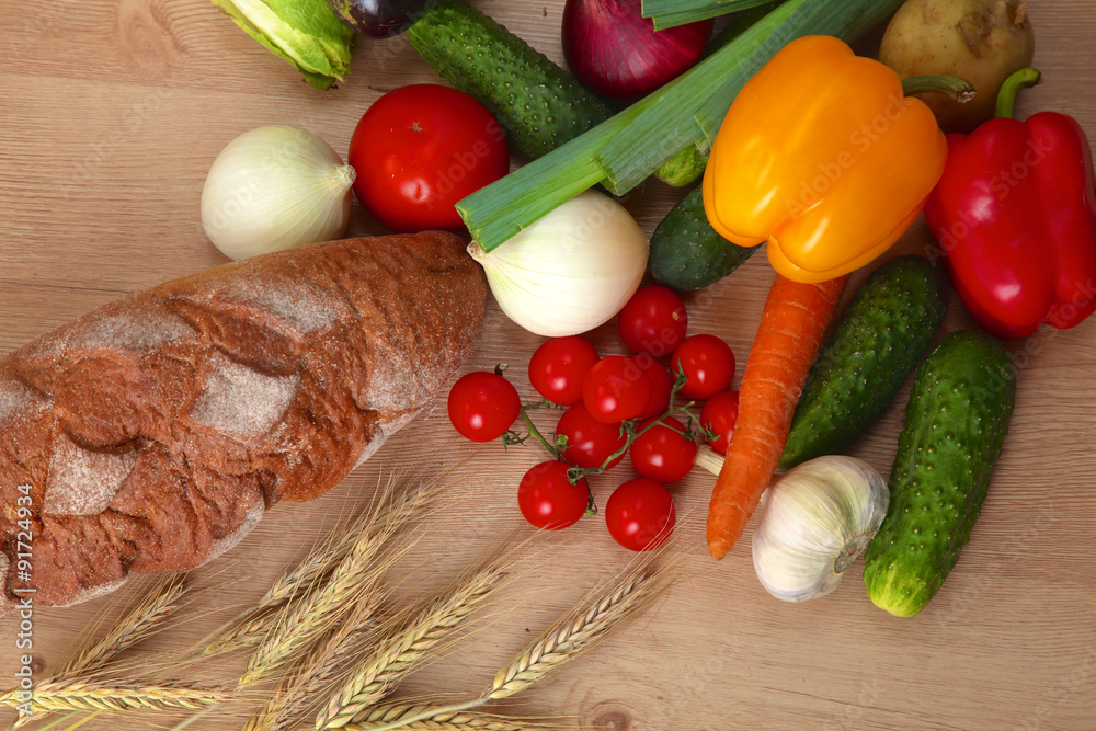 Pile of organic vegetables on a wooden table Pile of organic vegetables on a wooden table