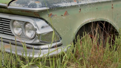 An old Ford Edsel sits in a field. photo