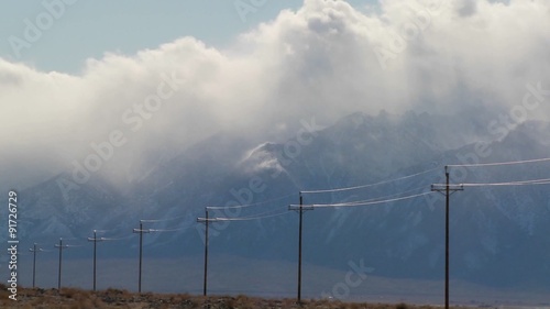Time lapse over the Sierra Nevadas with telephone poles in the foreground.