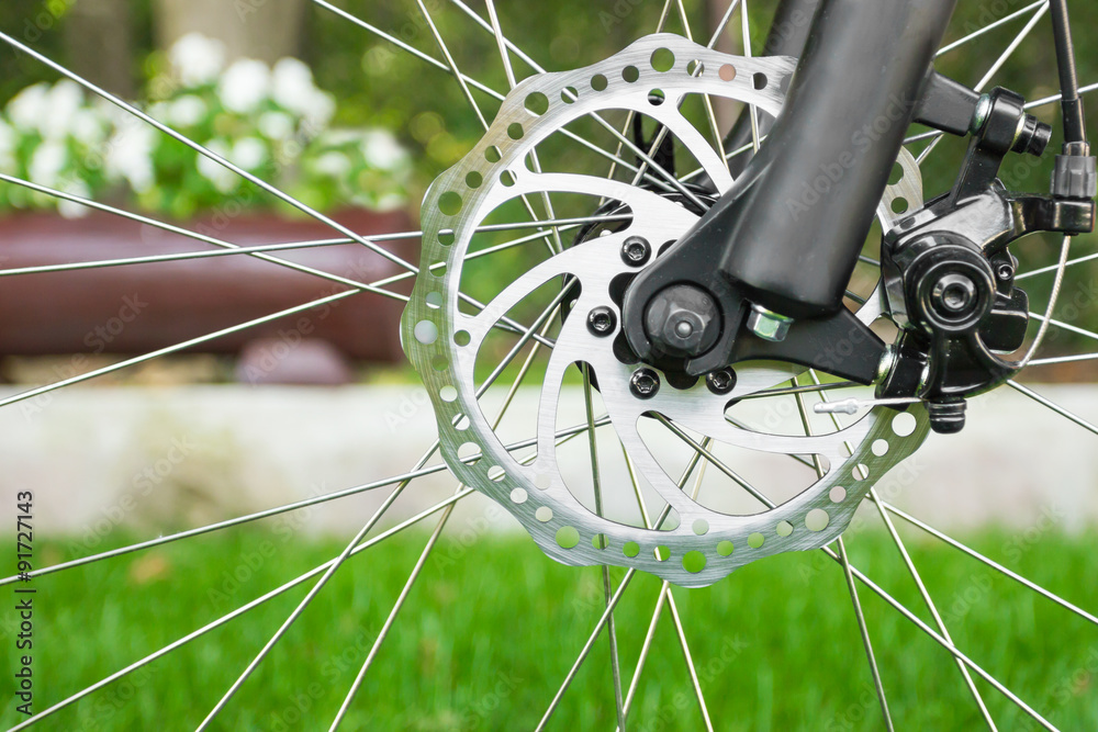 Naklejka premium Metal disc brake detail on mountain bicycle