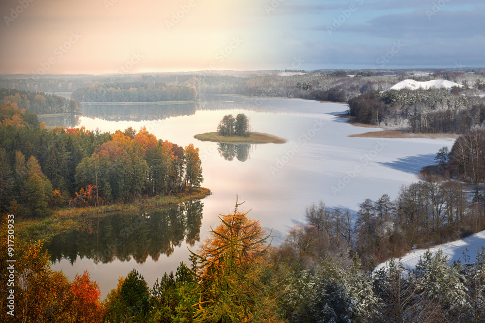 Lake Jedzelwo in autumn  and winter. Composition fifty fifty. Masuria, Stare Juchy, Poland.